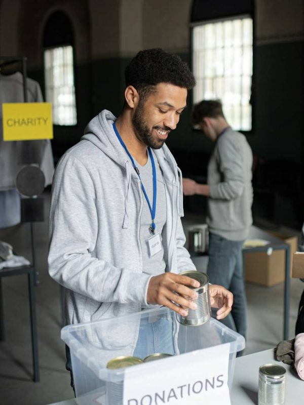 volunteers-working-in-community-charity-donation-center-sorting-out-clothes-and-canned-food-.jpg